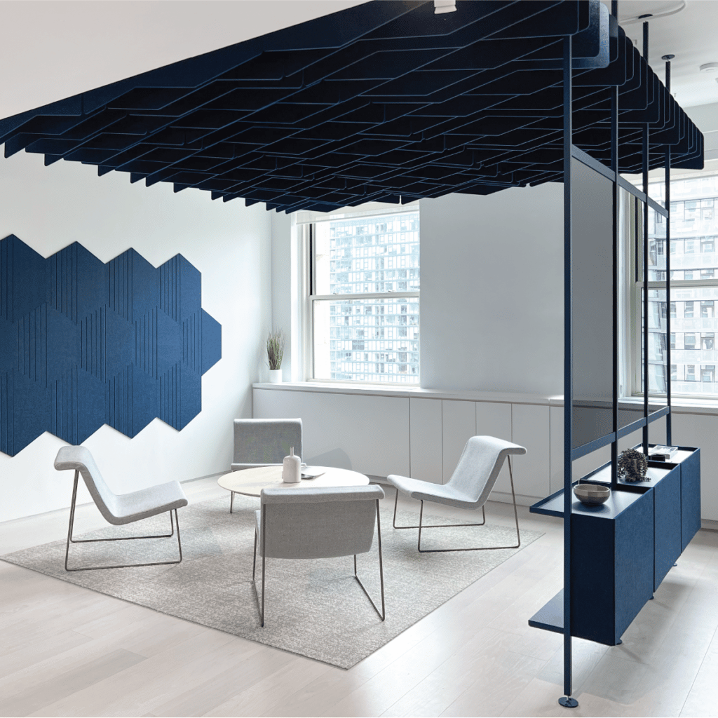 Navy Tempo ceiling baffle system hung above soft seating area by downtown windows
