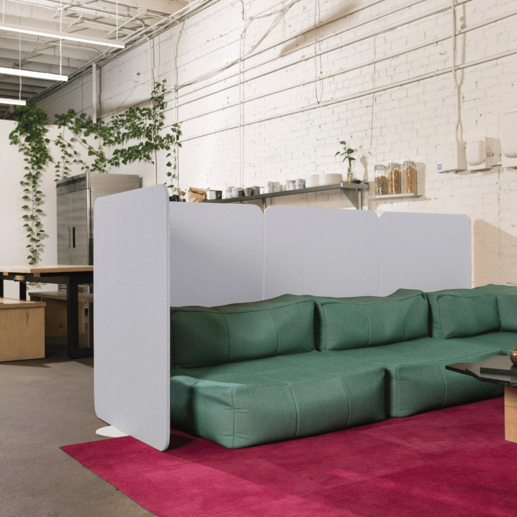 Loftwall room dividers Buffer behind a green couch separating a break area from the office kitchen