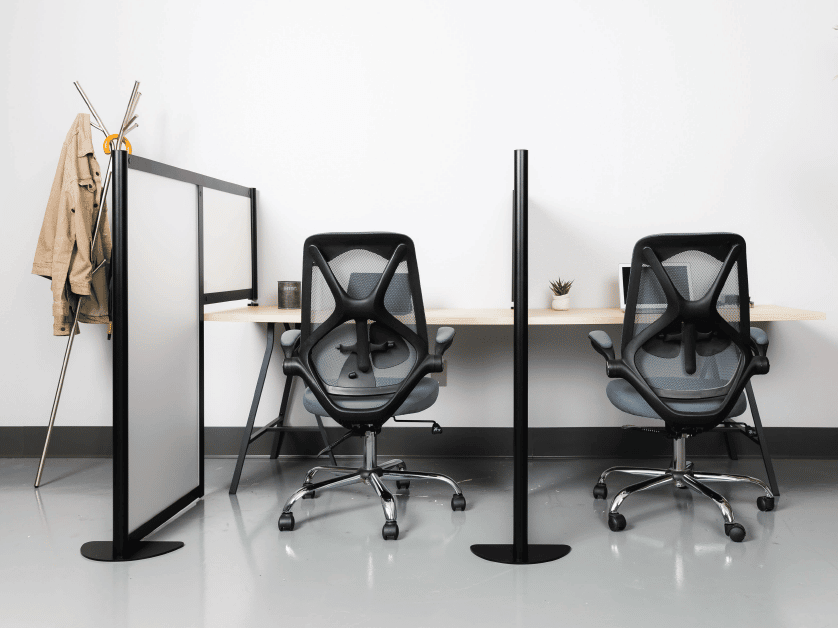 Two Loftwall hitch panels on either side of a office chairs working in a bench seating style workstation