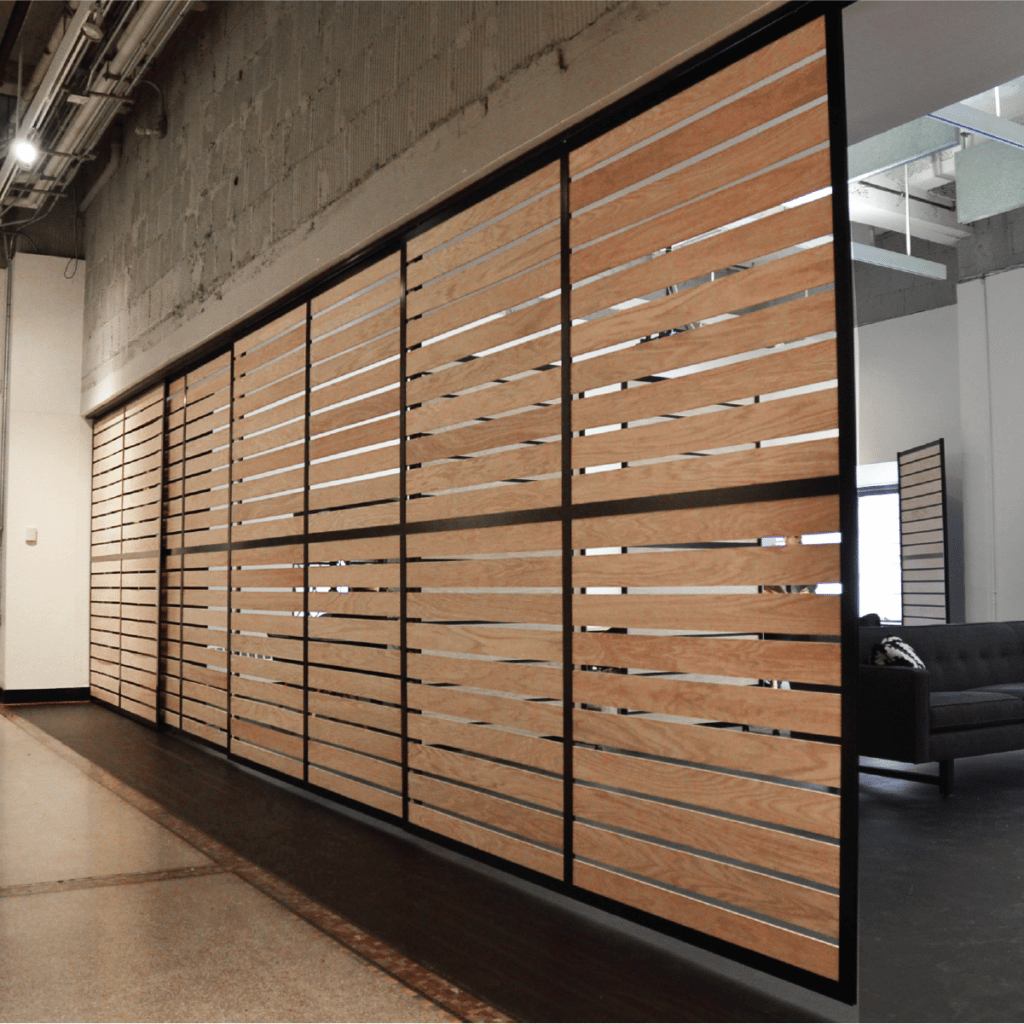 Loftwall Glide sliding track system partition with wooden slat insert panels